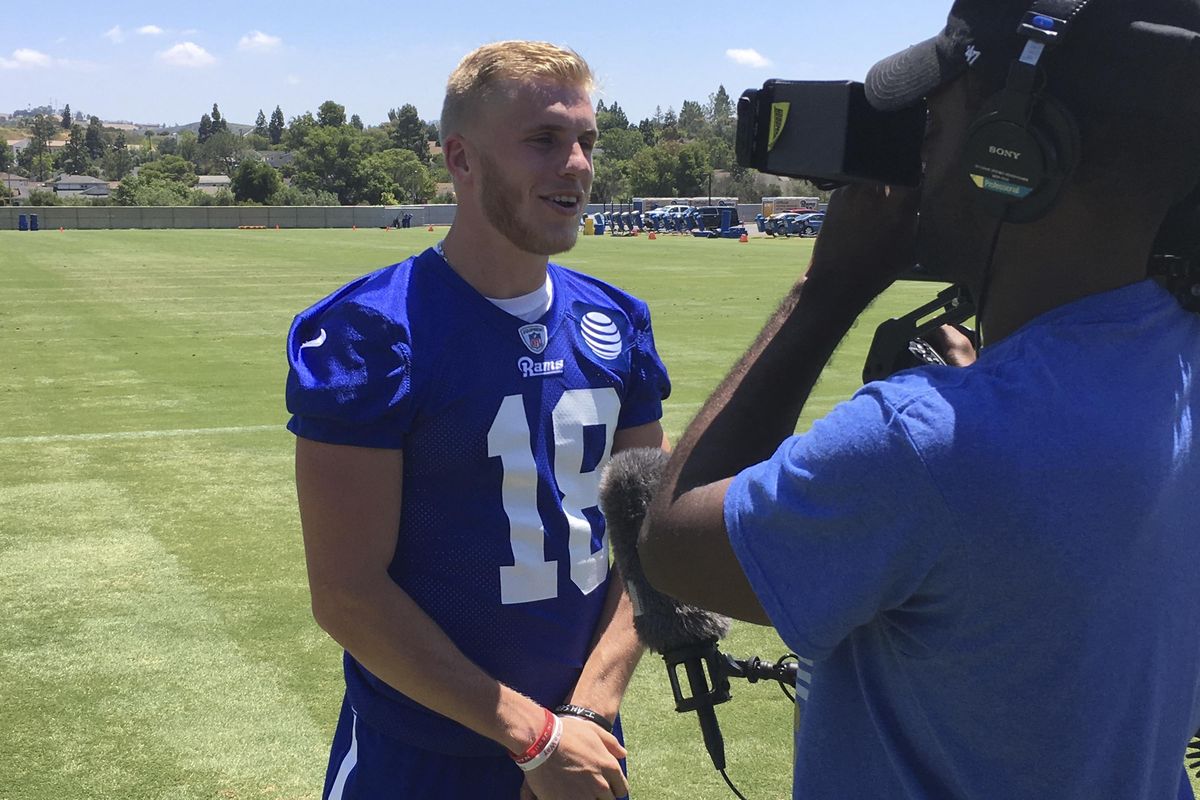 Los Angeles Rams receiver Cooper Kupp, left, participates in an team interview after practice last week. (Greg Beacham / Associated Press)