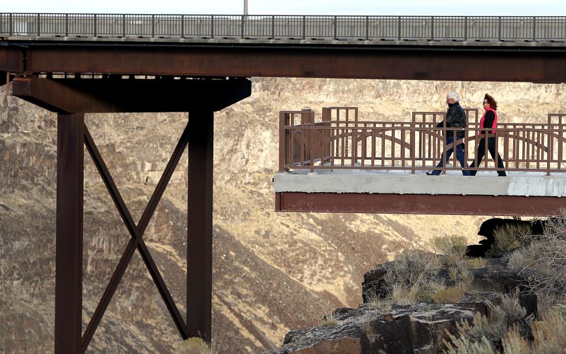 John Helgesen, left, and Susan Kolbo, both of Wisconsin, walk on the new 43-foot-by-21-foot steel cantilever overlook at the Buzz Langdon Visitor Center in Twin Falls, Idaho on Nov. 15, 2010. (Ashley Smith / Times-news)