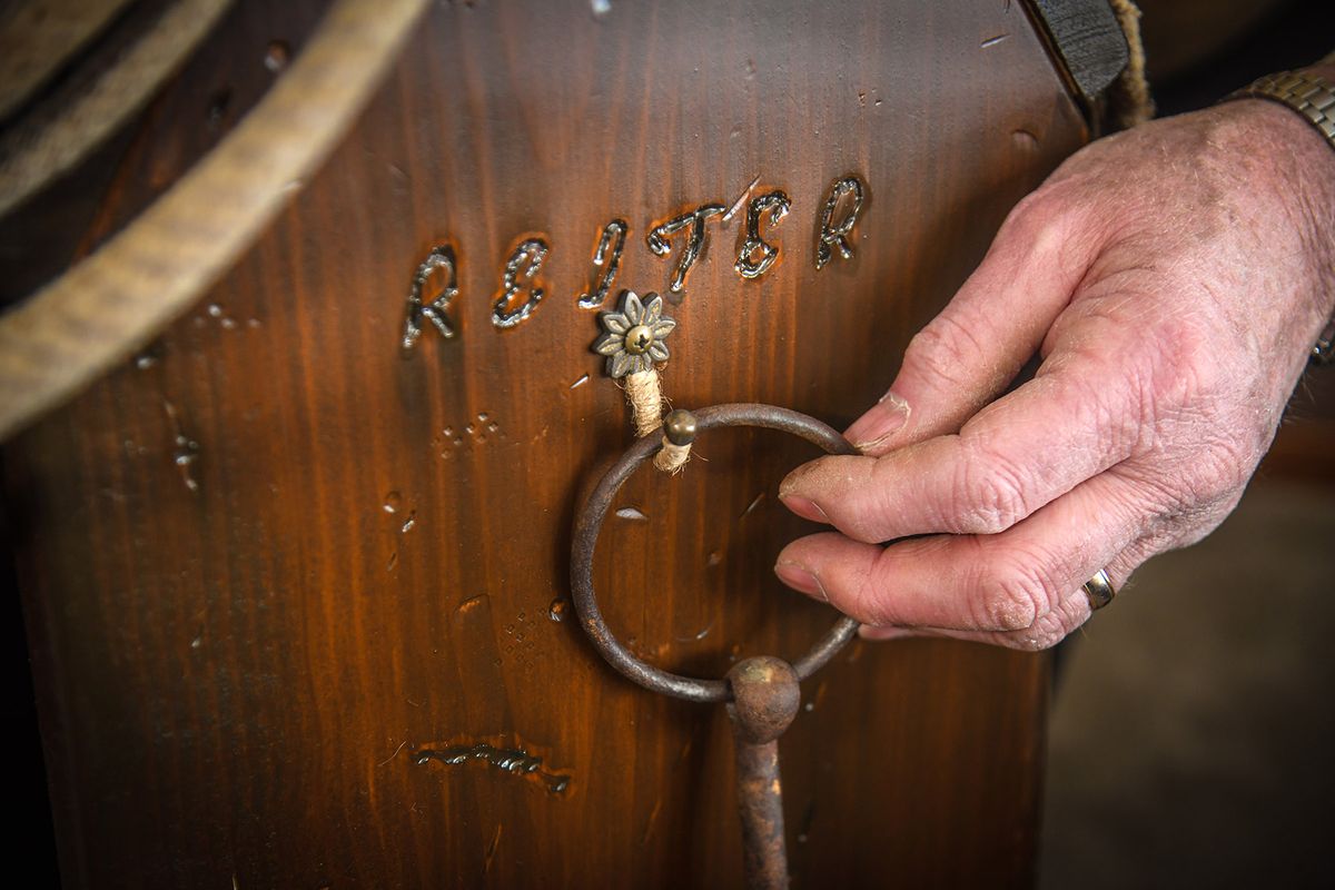 Mike Reiter etched his name into the display stand he built for his saddle.  (DAN PELLE/THE SPOKESMAN-REVIEW)