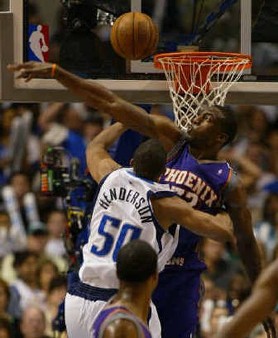 
Phoenix's Amare Stoudemire  blocks a shot by Alan Henderson  of the Mavericks in the first half of Game 3. 
 (Associated Press / The Spokesman-Review)
