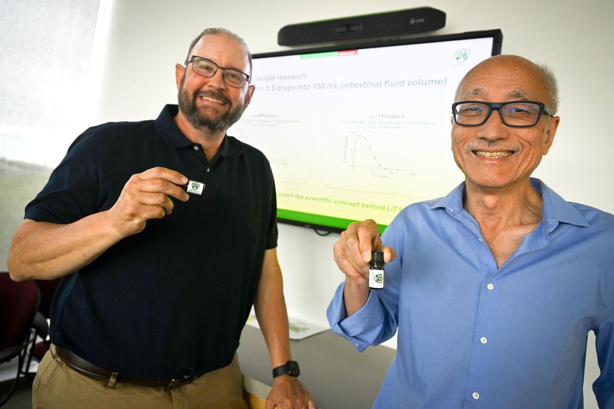WSU professors Travis Denton, left, and Albert Li are partners in LiT Protect, a compound of essential oils that limit the metabolizing of nicotine and the absorbing of carcinogens found in smoking. The scientists are shown Monday at WSU Spokane, where they use a lab to produce tiny bottles of oils that they sell over the counter.  (Jesse Tinsley/THE SPOKESMAN-REVIEW)