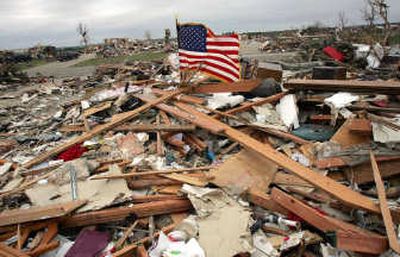 
An American flag waves atop a home in ruins Tuesday in Parkersburg, Iowa, devastated over the weekend by a powerful tornado. Associated Press
 (Associated Press / The Spokesman-Review)