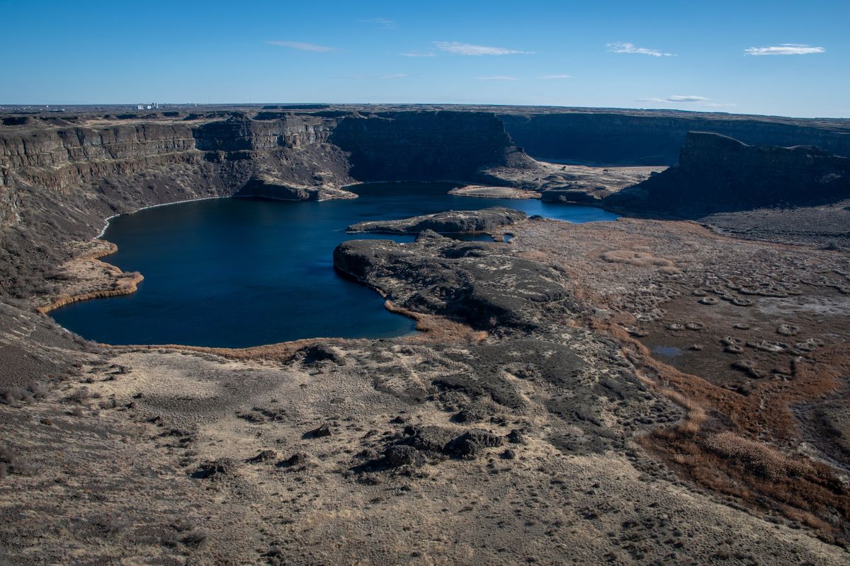 Dry Falls, just south of Coulee City, was once home to an enormous waterfall. Cataclysmic floods tore across the landscape, creating the Channeled Scablands.  (Colin Tiernan/The Spokesman-Review)