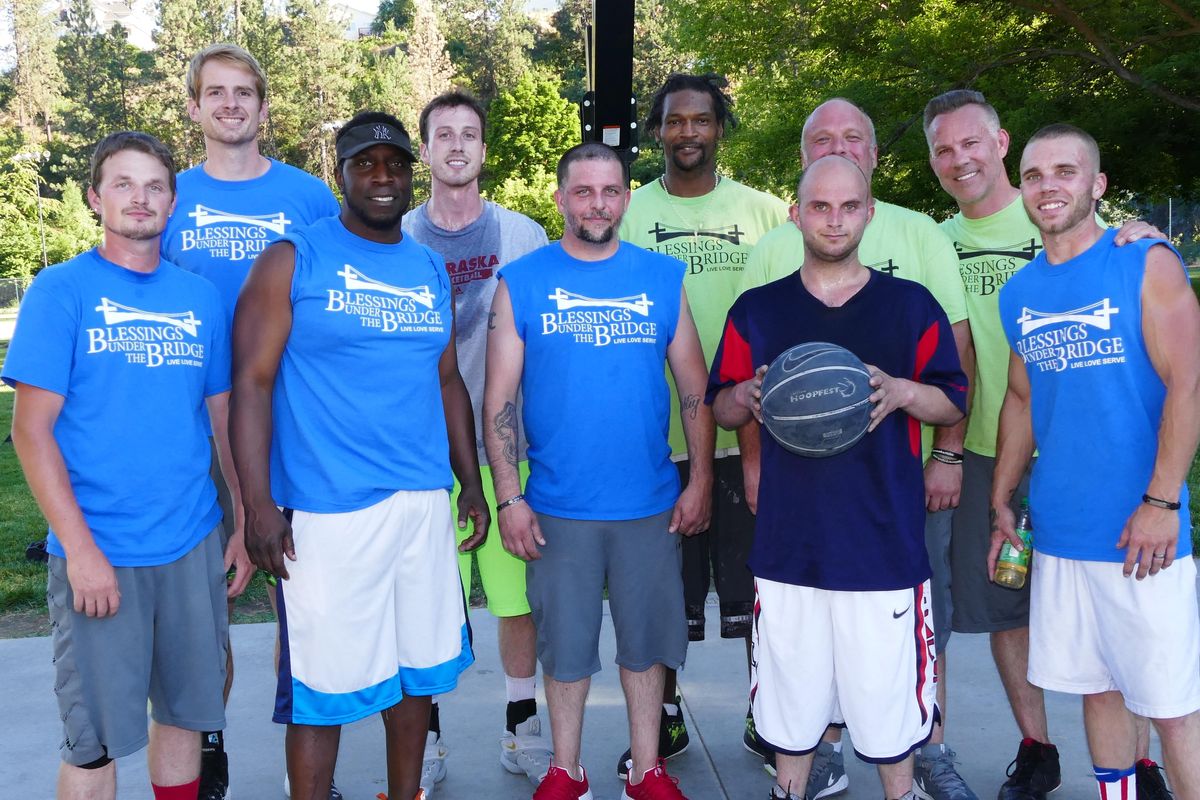 Members and coaches of two Blessings Hoopfest teams  pose for a photo Friday at Liberty Park. (Jesse Tinsley / The Spokesman-Review)