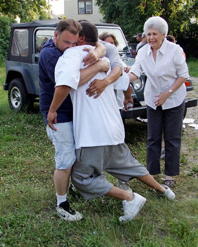 
David Agosto, center, father of missing boy Daniel Agosto, collapses in the arms of a friend  after the discovery of the bodies of Jesstin Pagan, 5, Daniel Agosto, 6, and Anibal Cruz, 11. The boys had been missing since Wednesday. 
 (Associated Press / The Spokesman-Review)