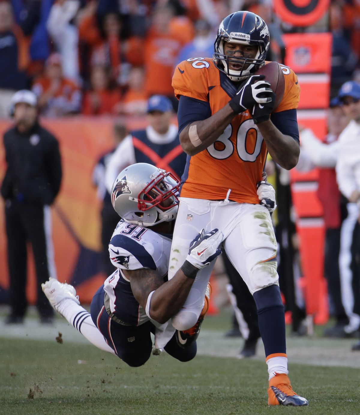Patriots outside linebacker Jamie Collins tries to bring down Broncos tight end Julius Thomas as he heads downfield with the ball. (Associated Press)
