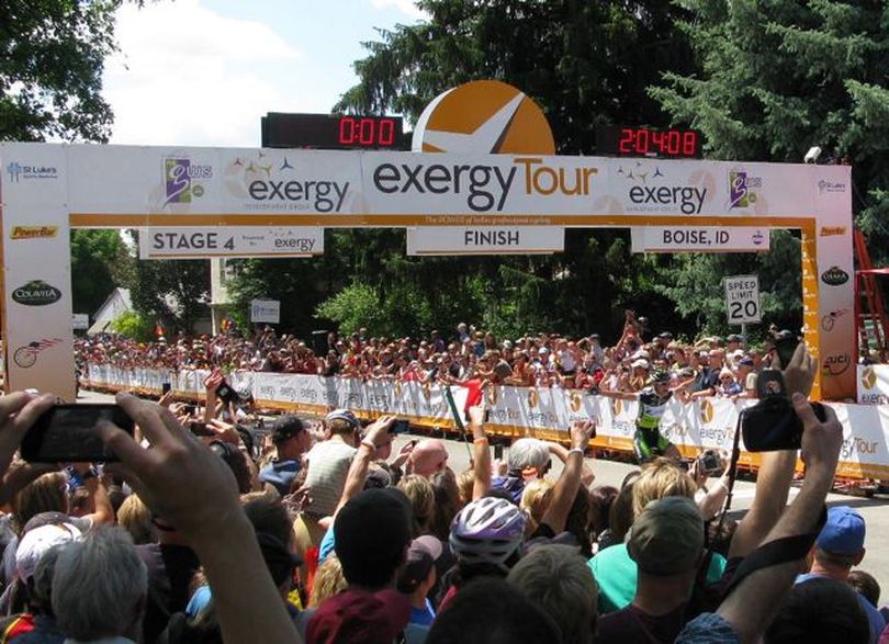 German rider Claudia Hausler crosses the finish line in triumphant fashion at the final stage of the Exergy Tour on Monday; American Evelyn Stevens, who won the overall tour, was close behind. (Betsy Russell)