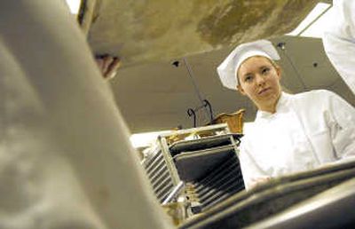 
Kimberly Thom, of Lakeland High School, listens to instruction while in the kitchen at the Coeur d'Alene Resort Dec. 12. 
 (Kathy Plonka / The Spokesman-Review)