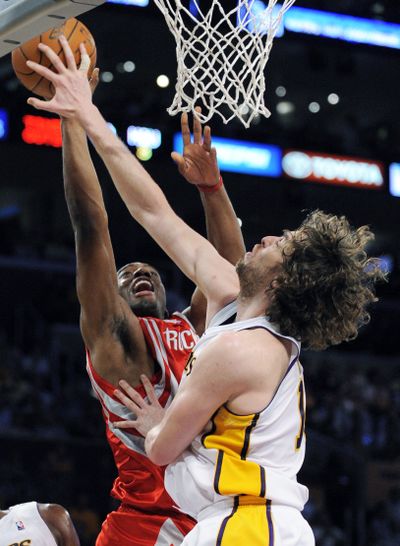 The Lakers’ Pau Gasol blocks a shot by the Rockets’ Carl Landry. (Associated Press / The Spokesman-Review)