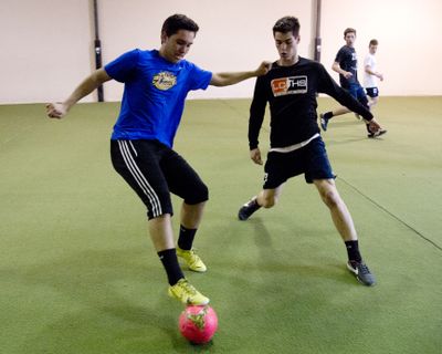 Lewis and Clark’s Henry Smaldon, left, and Jackson Moore go one on one during Tuesday’s indoor practice. (Jesse Tinsley)