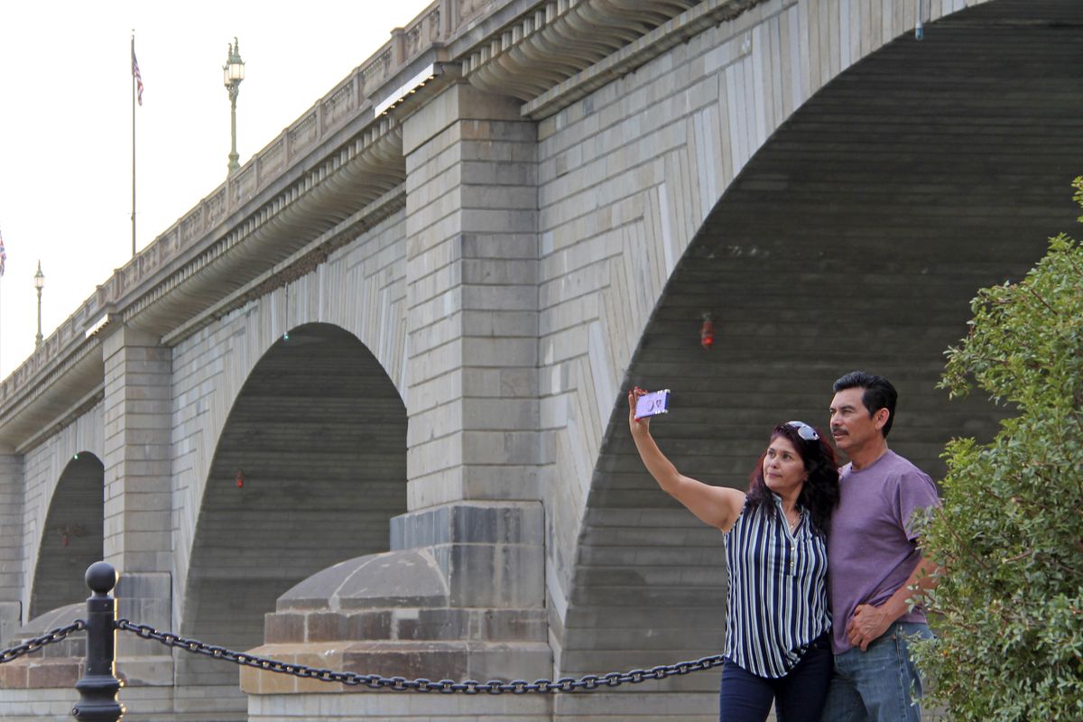 Claudia and Rafael Lopez take a selfie in front of the London Bridge on Sept. 25 in Lake Havasu City, Ariz.  (Daisy Nelson)