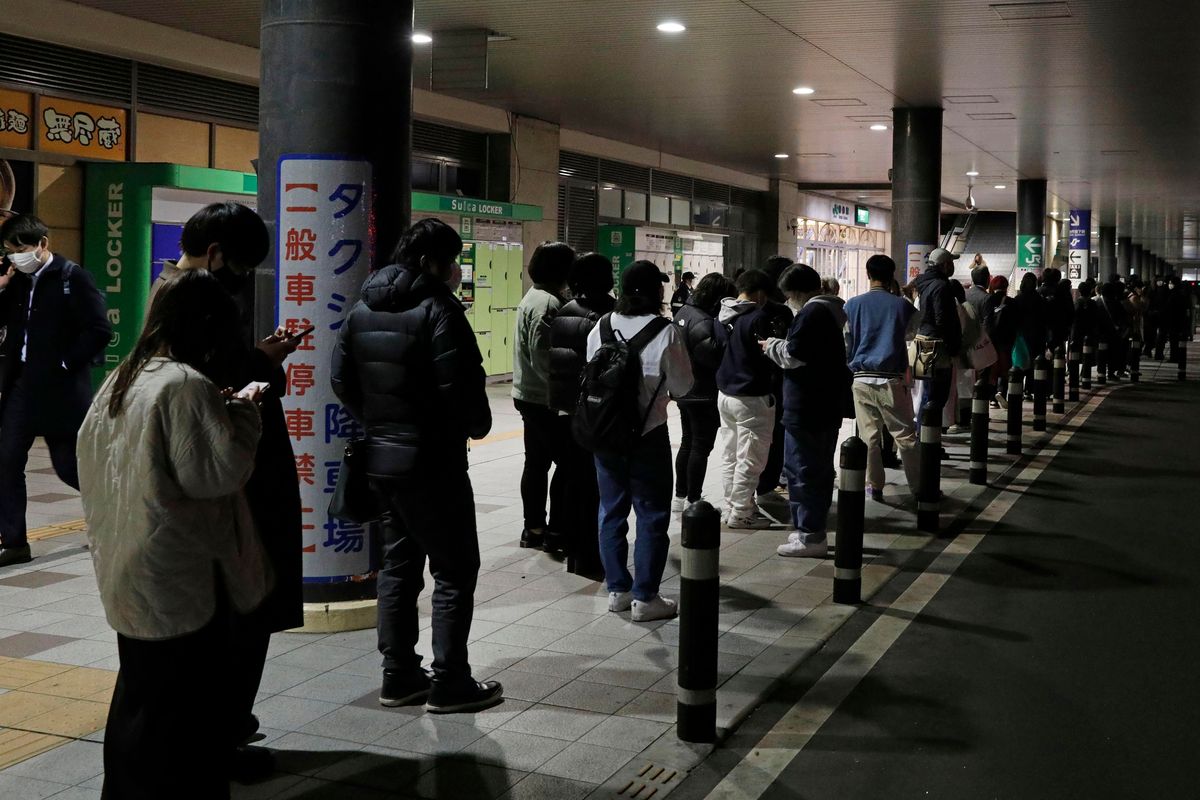 People make a line to wait for taxi in Sendai, Miyagi prefecture, northern Japan early Thursday, March 17, 2022, following an earthquake. A powerful earthquake struck off the coast of Fukushima in northern Japan on Wednesday evening, triggering a tsunami advisory and plunging more than 2 million homes in the Tokyo area into darkness. (SUB)