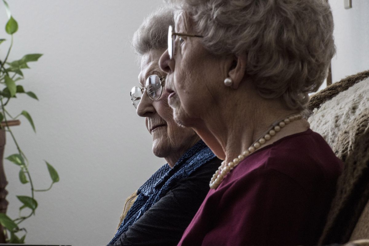 Sisters Viola Beyers, left, and Mabel Gunning talk about being centenarians and living at Holman Gardens in Spokane on Monday. (Kathy Plonka / The Spokesman-Review)