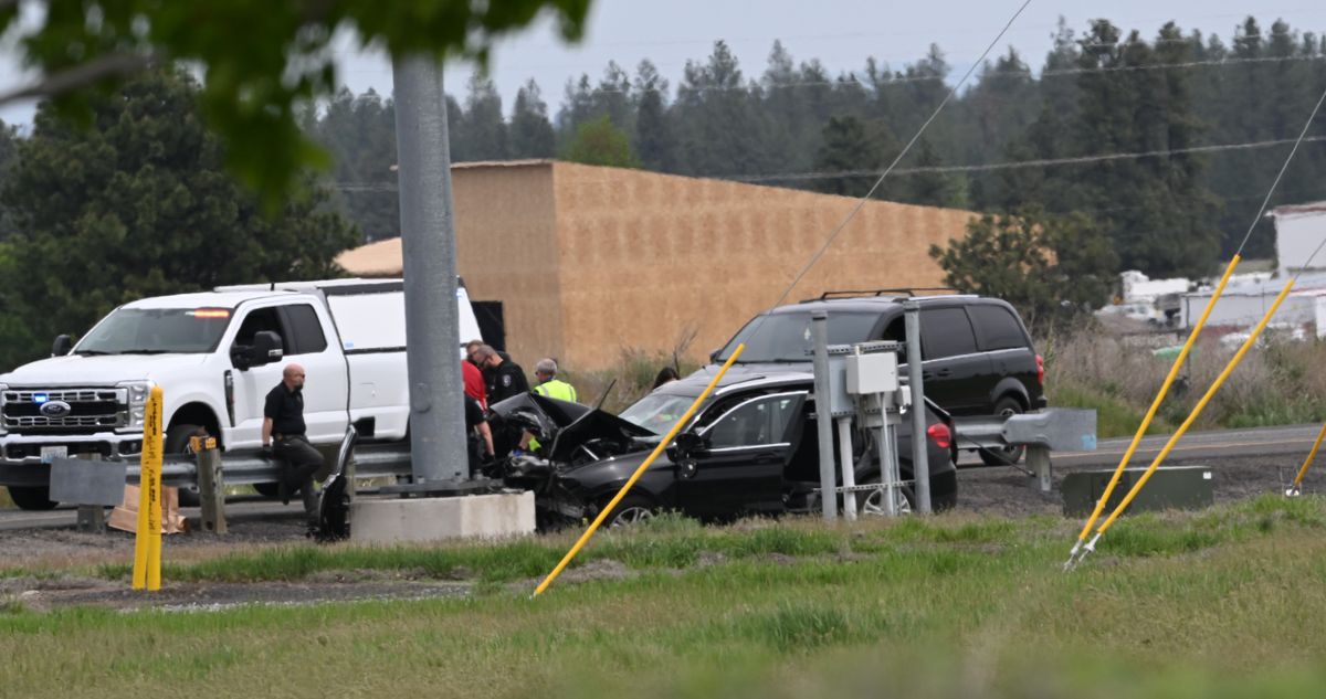 Police investigate the scene of a fatal crash on May 8 on West Airport Drive near Spokane International Airport. The car struck the concrete base of a pole.  (Jesse Tinsley/THE SPOKESMAN-REVIEW)