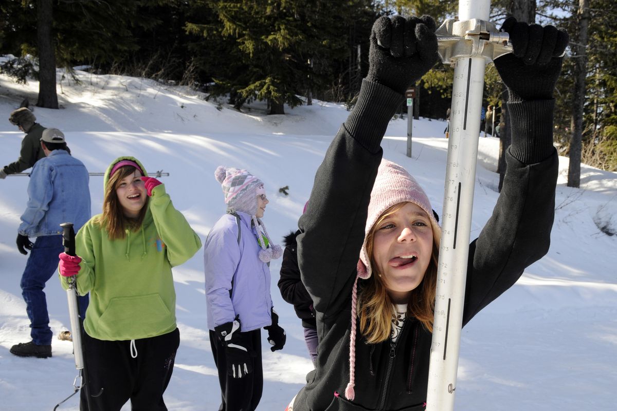 Isabella McSpadden, 13, of West Valley City School, struggles to drive a sampling tube into the snow as students measure the snowpack at Mount Spokane with the help of the Natural Resources Conservation Service. (Dan Pelle)
