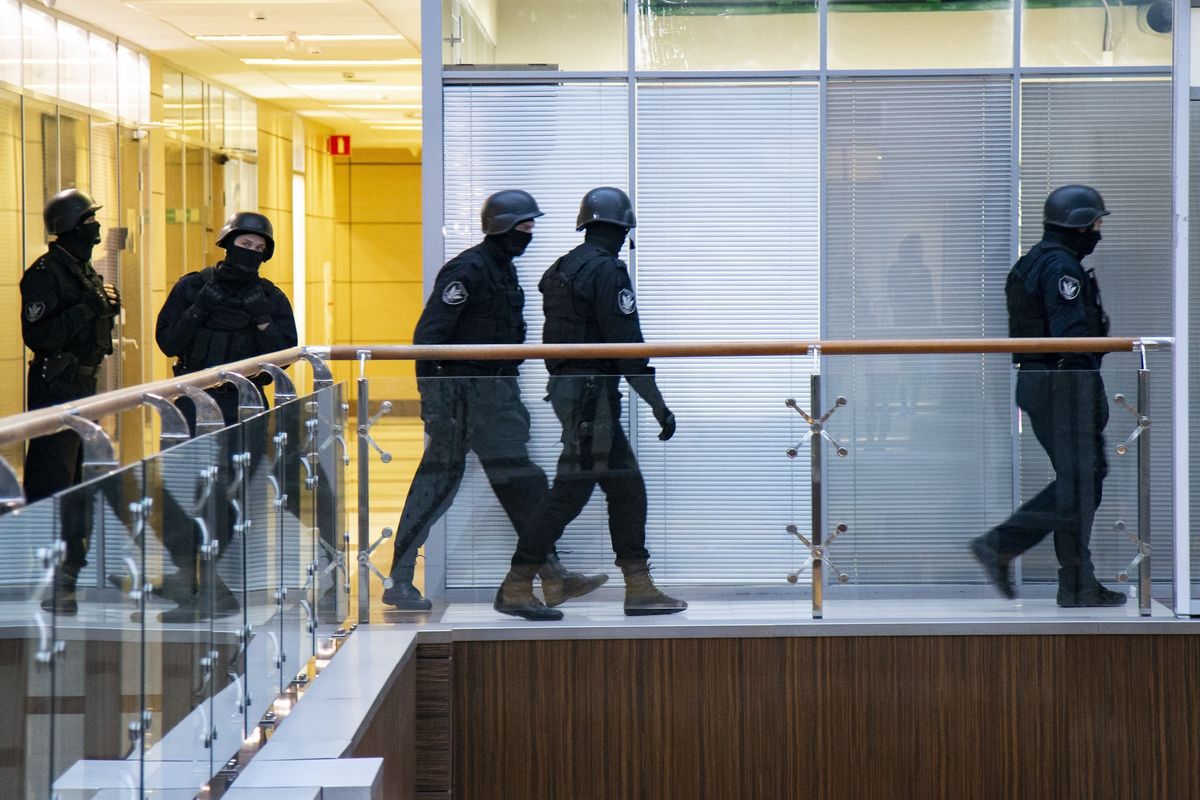 FILE- In this file photo taken on Thursday, Dec. 26, 2019, Russian security officers walk at the Foundation for Fighting Corruption office in Moscow, Russia. A court in Moscow has ruled Tuesday April 27, 2021, to restrict activities of an organization founded by Russia
