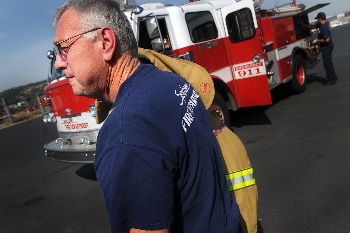 Spokane Fire Capt. Doug Bacon is seen in this Sept. 11, 2008, photo, returning to work after a bout with throat cancer and losing three friends to the disease. (File)