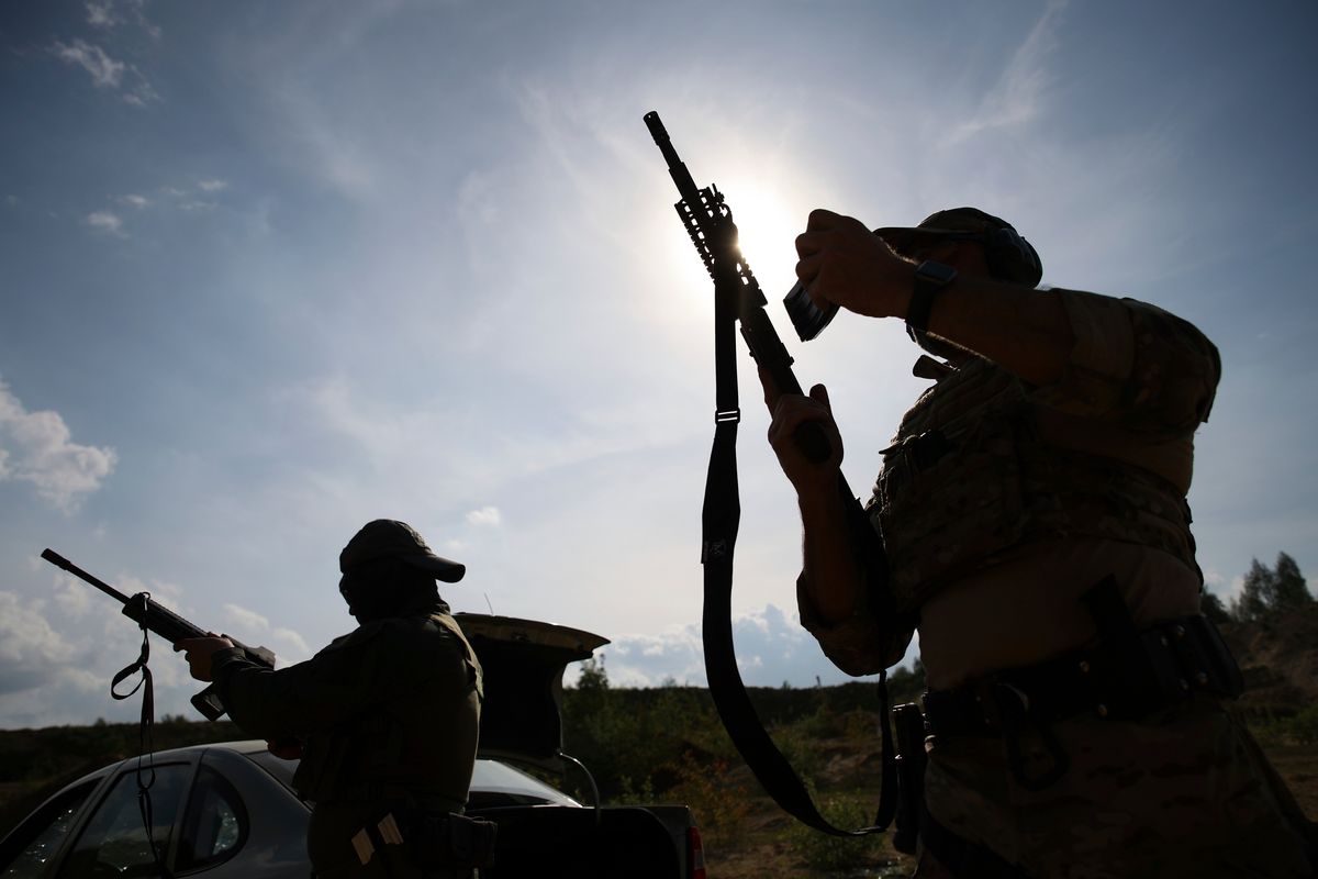 Volunteers from Belarus practice at a shooting range near Warsaw, Poland, on Friday, May 20, 2022. Belarusians are among those who have answered a call by Ukrainian President Volodymyr Zelenskyy for foreign fighters to go to Ukraine and join the International Legion for the Territorial Defense of Ukraine.  (Michal Dyjuk)