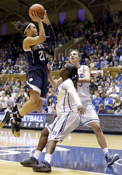 Kayla McBride, shooting over Duke’s Alexis Jones and Haley Peters, right, had 23 points and 11 rebounds for Notre Dame. (Associated Press)