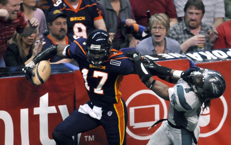The Spokane Shock's Huey Whittaker (17) lays a stiff arm on Bossier-Shreveport's Roland Cola while on his way to a 43-yard touchdown in the second quarter Saturday, April 17, 2010, in the Spokane Arena. (Dan Pelle / The Spokesman-Review)