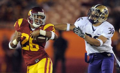 Marc Tyler and the Trojans ran away from the Huskies all day. (Associated Press / The Spokesman-Review)