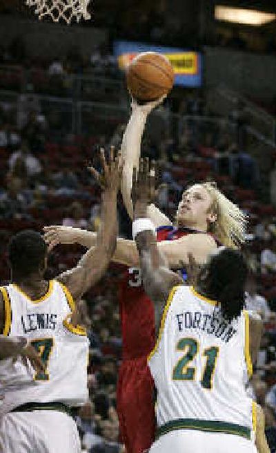 
Seattle's Rashard Lewis and Danny Fortson defend a shot by the Clippers' Chris Kaman. 
 (Associated Press / The Spokesman-Review)
