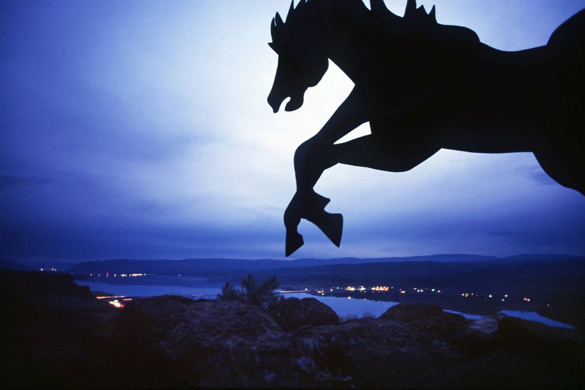 The lead horse from David Govedare’s wild horse monument sculpture forms a silhouette against the evening sky in 1995 over the Columbia River above Vantage, Wash.  (Shawn Jacobson/The Spokesman-Review)