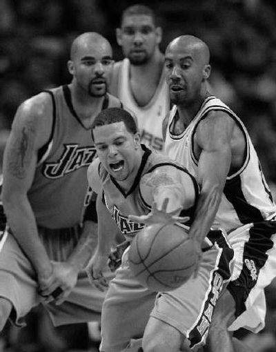 
Utah guard Deron Williams reaches for a loose ball as San Antonio forward Bruce Bowen defends.
 (Associated Press / The Spokesman-Review)