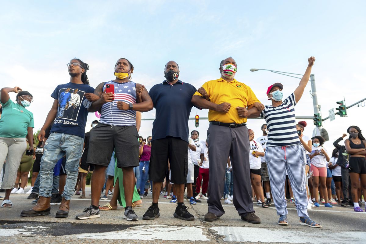 Protesters take to the street and block traffic at the intersection of Willow Street and Evangeline Thruway after a vigil held Saturday in Lafayette, La., for 31-year-old Trayford Pellerin, who was shot and killed by Lafayette police officers while armed with a knife the night before.  (Scott Clause)