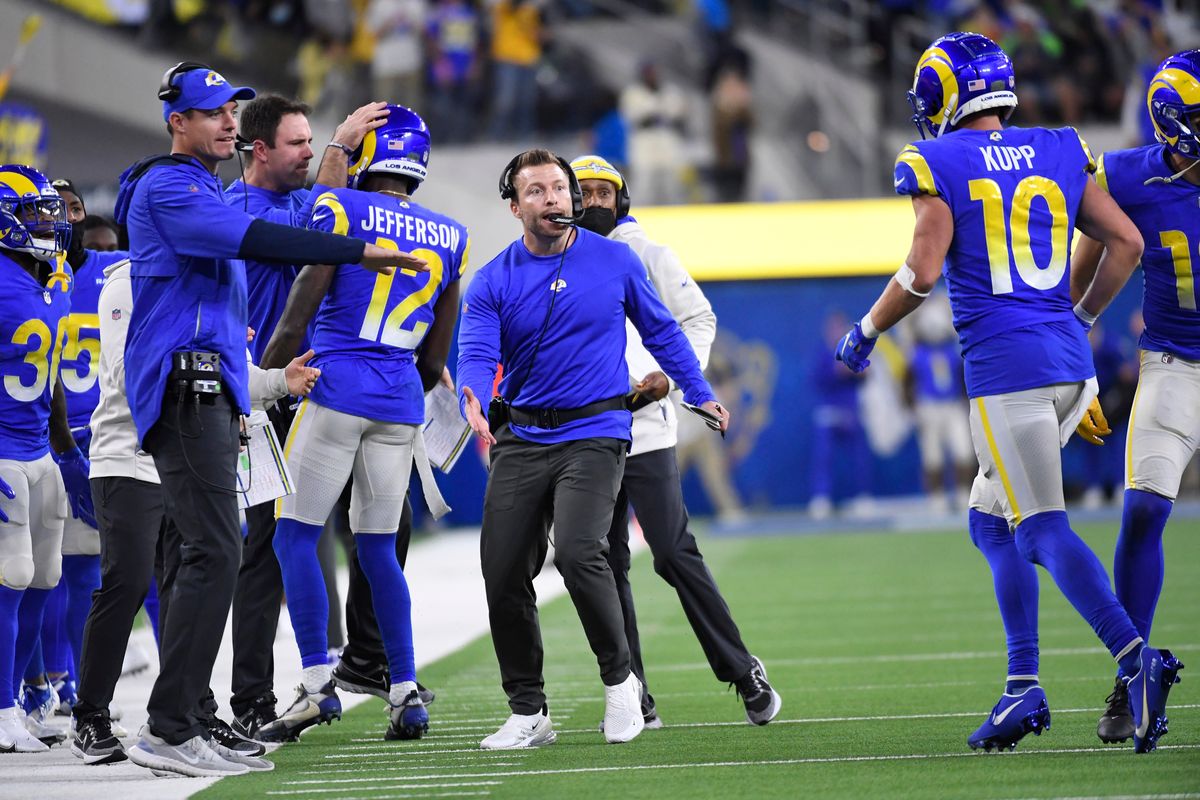 Los Angeles Rams wide receiver Cooper Kupp (10) returns to the sideline and a welcome from coach Sean McVay, center, after a touchdown reception during the second half of an NFL football game against the Seattle Seahawks on Tuesday, Dec. 21, 2021, in Inglewood, Calif.  (Kevork Djansezian)