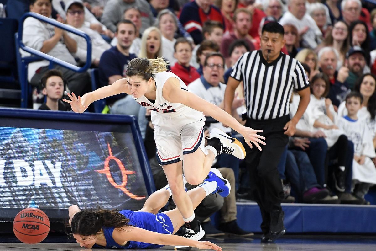 Gonzaga Bulldogs guard Katie Campbell (24) dives for a loose ball against BYU Cougars guard Kaylee Smiler (11) during the first half of a college basketball game on Saturday, February 1, 2020, at McCarthey Athletic Center in Spokane, Wash. (Tyler Tjomsland / The Spokesman-Review)