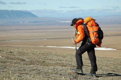 
This photo provided by Roman Dial shows Ryan Jordan hiking along a ridge in the Kukpowruk River uplands in June, about 100 miles from Kivalina, Alaska. Jordan, Roman Dial and Jason Geck set off on a 622-mile hike across northwest Alaska following animal paths, picking routes along gravel bars and ridge tops as they moved first north and then east from the village of Kivalina on the Chukchi Sea. 
 (Associated Press / The Spokesman-Review)