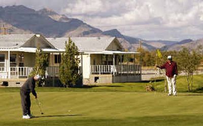 
Golfers putt on the par-3 gold course at the Desert Greens Community in Pahrump, Nev. Retirees eager to escape cold winters or congested freeways have been flocking to western cities like Pahrump. 
 (Associated Press / The Spokesman-Review)
