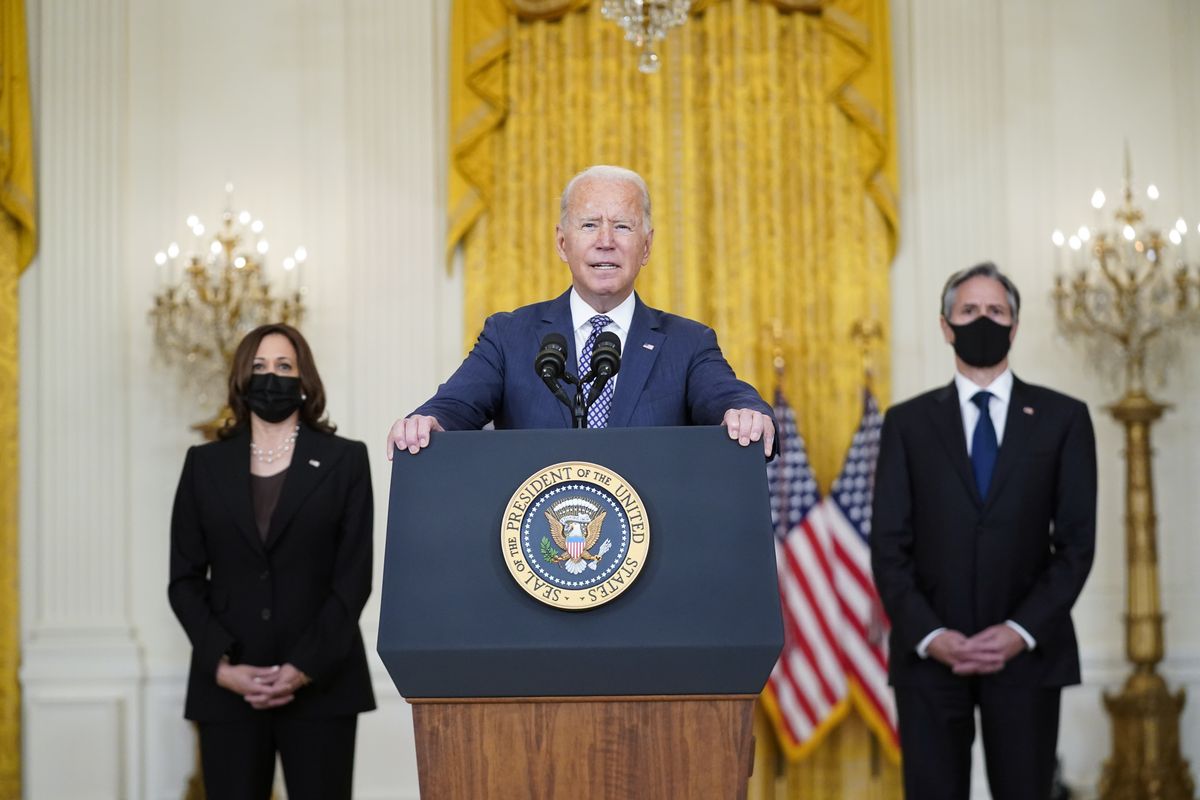 President Joe Biden speaks about the evacuation of American citizens, their families, SIV applicants and vulnerable Afghans in the East Room of the White House, Friday, Aug. 20, 2021, in Washington. Vice President Kamala Harris, left, and Secretary of State Antony Blinken, right, listen.  (Manuel Balce Ceneta)