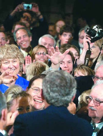 
President Bush works the front row of the crowd after speaking in support of Senate candidate George Nethercutt in Spokane Thursday.
 (The Spokesman-Review)