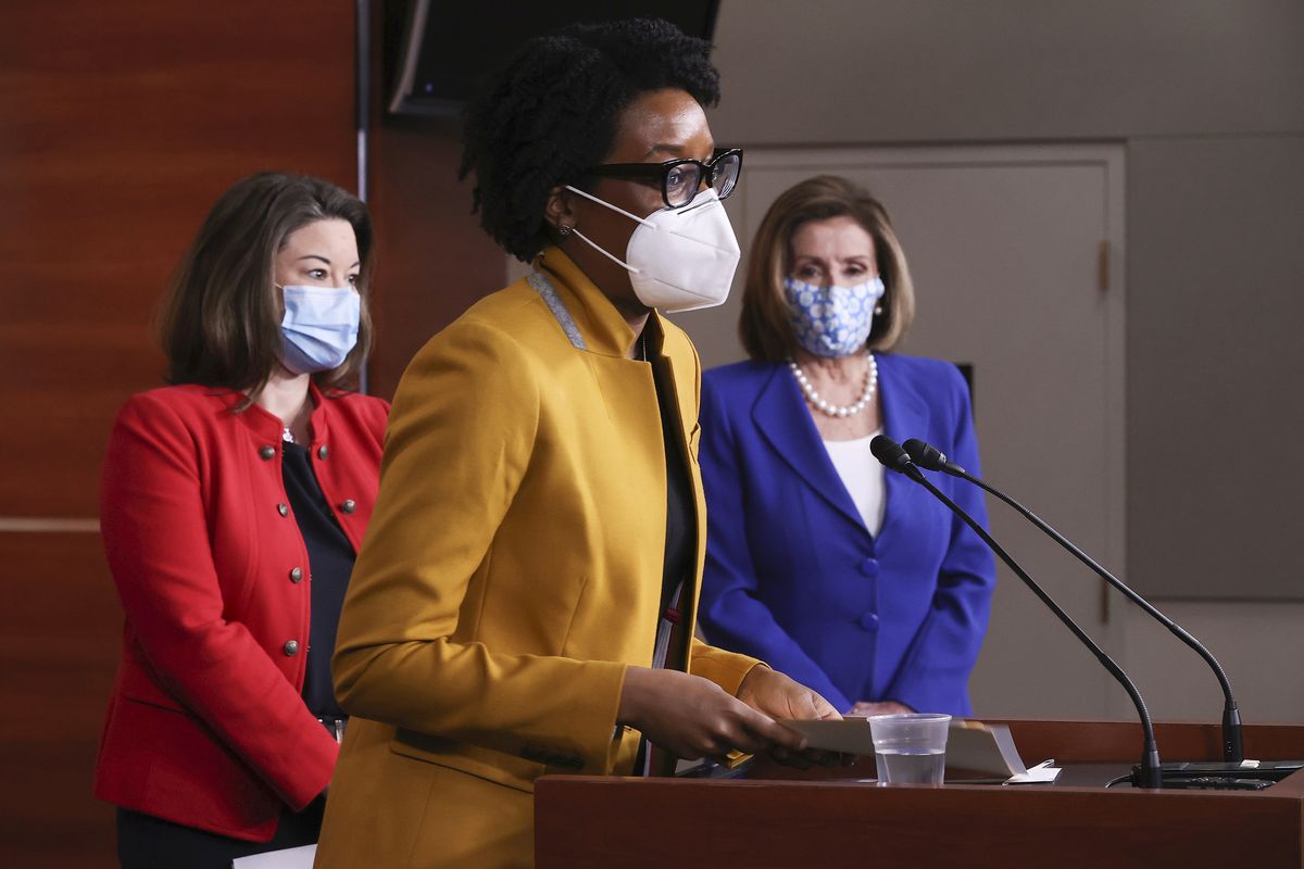 Rep. Lauren Underwood, D-Ill., center, speaks during a news conference with Speaker of the House Nancy Pelosi, D-Calif., right, and Rep. Angie Craig, D-Minn., left, on Capitol Hill in Washington, Friday, March 19, 2021.  (Chip Somodevilla)