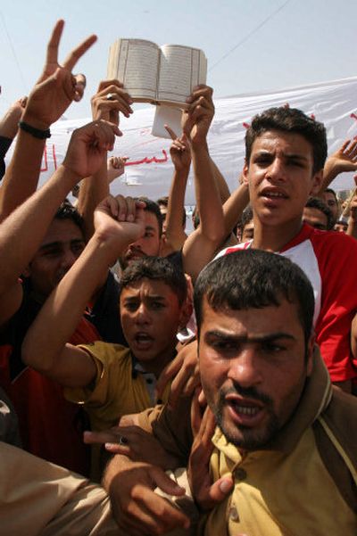 
Iraqis demonstrate chanting slogans against the constitution Sunday in Ramadi, a predominately Sunni city west of Baghdad.
 (Associated Press / The Spokesman-Review)