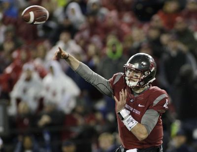 Washington State quarterback Luke Falk is denying that he has made a decision to enter the NFL draft. (Young Kwak / Associated Press)
