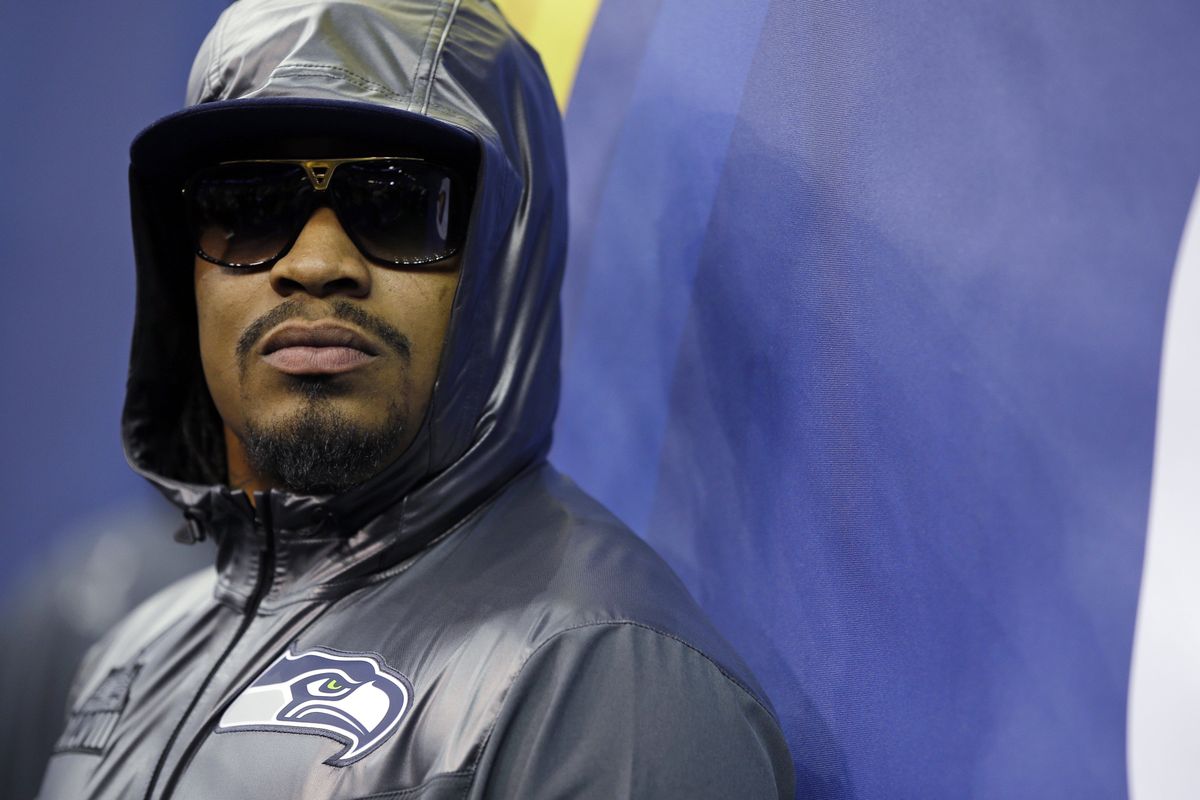 Seattle running back Marshawn Lynch is decked out in shades and a new Seahawks Super Bowl hoodie for media day Tuesday. (Associated Press)