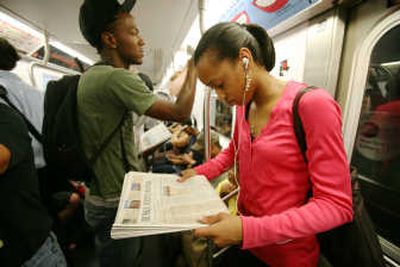 
Andrea Alexander reads the Wall Street Journal on her subway commute to work Wednesday in New York. Rupert Murdoch has sealed a deal to buy Wall Street Journal publisher Dow Jones & Co. for $5 billion, ending a century of family ownership and adding a crown jewel to his global media empire, News Corp. Associated Press
 (Associated Press / The Spokesman-Review)