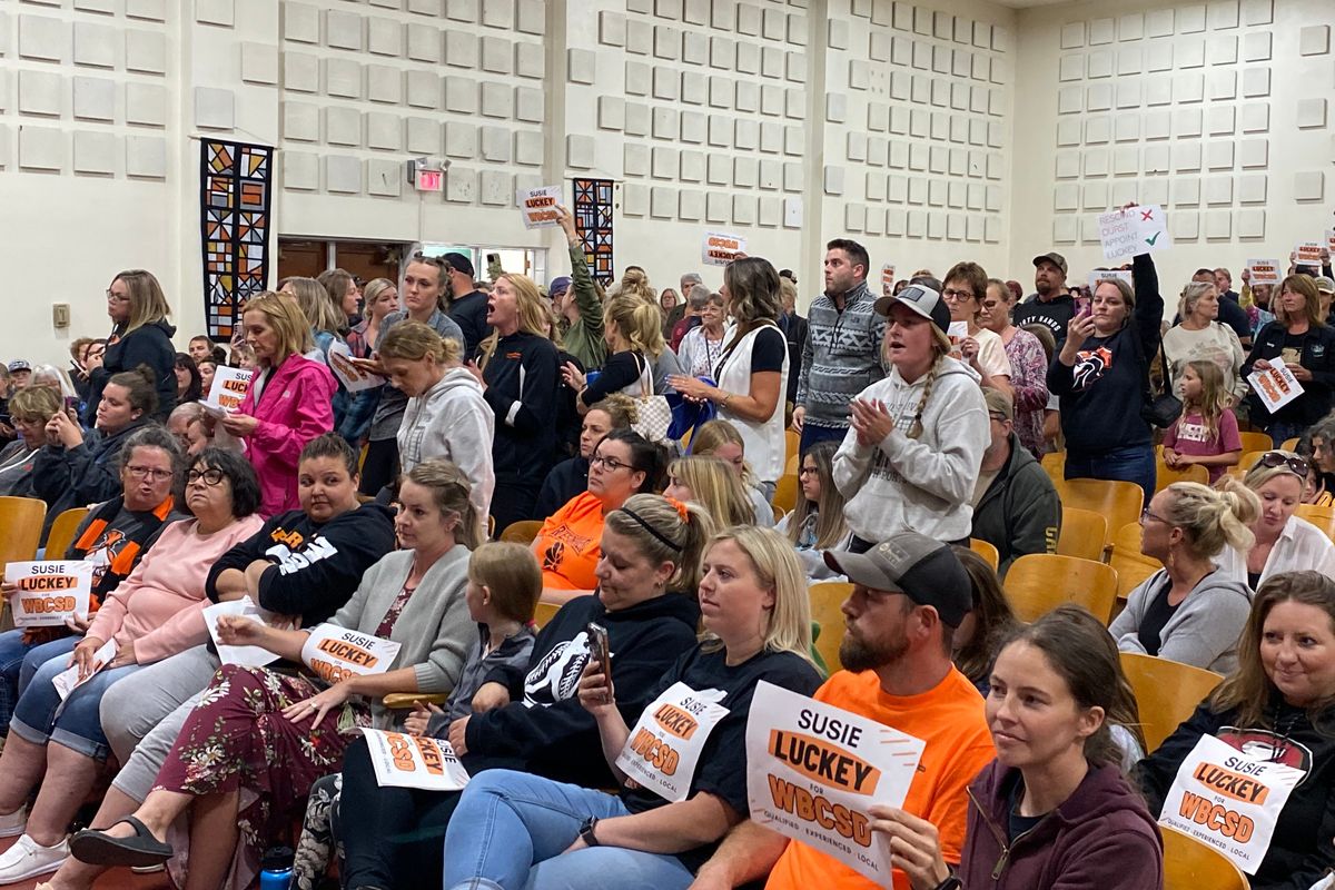 A mostly full auditorium boos after the West Bonner school board adjourned June 14 without rescinding the decision to hire Branden Durst as superintendent.  (James Hanlon/The Spokesman-Review)