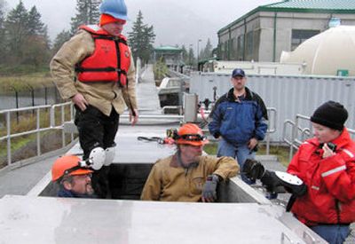 
 This December 2004 photo released by the Fish Passage Center shows center and U.S. Army Corps of Engineers personnel inspecting juvenile fish passage facilities at Bonneville Dam near North Bonneville, Wash. 
 (File/Associated Press / The Spokesman-Review)