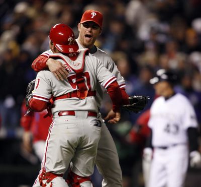 Phillies catcher Carlos Ruiz, left, embraces Brad Lidge as they celebrate a 5-4 victory. (Associated Press / The Spokesman-Review)