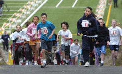 
Children participating in the 11-year-old age group head up the ramp and out onto the course during America's Kids Run at Joe Albi Stadium in Spokane last year.
 (File / The Spokesman-Review)