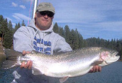 
Before releasing it back into the water, Bryan Duncan, a Coeur d'Alene biology teacher and fly fishing guide, holds a 34-inch rainbow he caught while trolling plugs on April 2. 
 (Photo by Pat Way / The Spokesman-Review)
