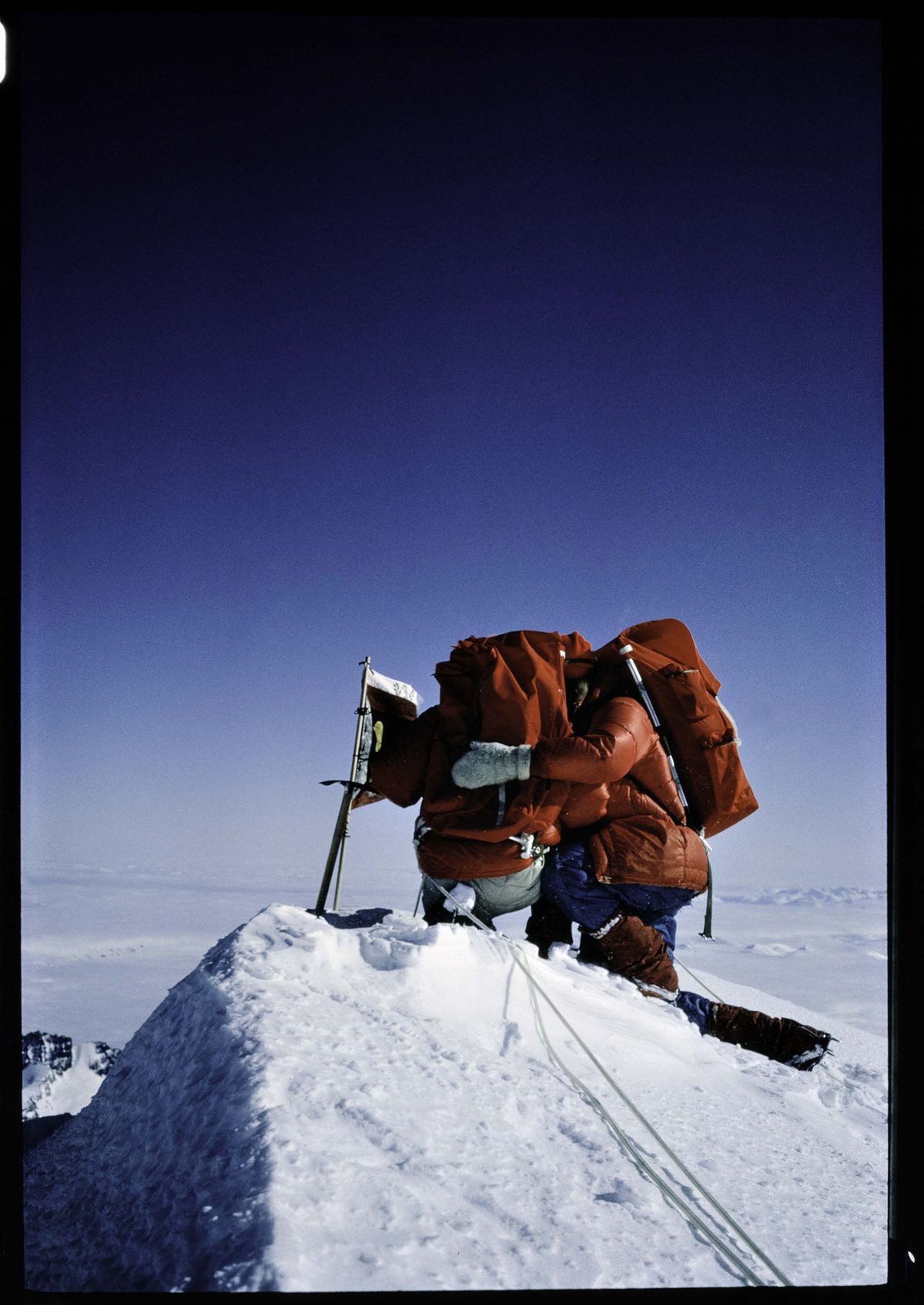 Jim Whittaker, right, kneels in prayer with Robert Kennedy, after they made the 1965 first ascent of Mount Kennedy in the Yukon. Canadian officials had named the peak in memory of President John F. Kennedy after his assassination (Albert Allard photo (National Geographic) courtesy of Whittaker Family Collection)