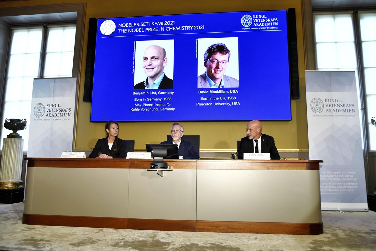 Goran K Hansson, Permanent Secretary of the Royal Swedish Academy of Sciences, centre, announces the winners of the 2021 Nobel Prize in Chemistry, in Stockholm, Sweden, Wednesday, Oct. 6, 2021. Professor Pernilla Wittung-Stafhede, is seated at left and Professor Peter Somfai at right. Two scientists have won the Nobel Prize for chemistry for finding an “ingenious” new way to build molecules that can be used to make everything from medicines to food flavorings. Benjamin List of Germany and Scotland-born David W.C. MacMillan developed “asymmetric organocatalysis.” Goran Hansson of the Royal Swedish Academy of Sciences said Wednesday that work has already had a significant impact on pharmaceutical research.  (Claudio Bresciani)