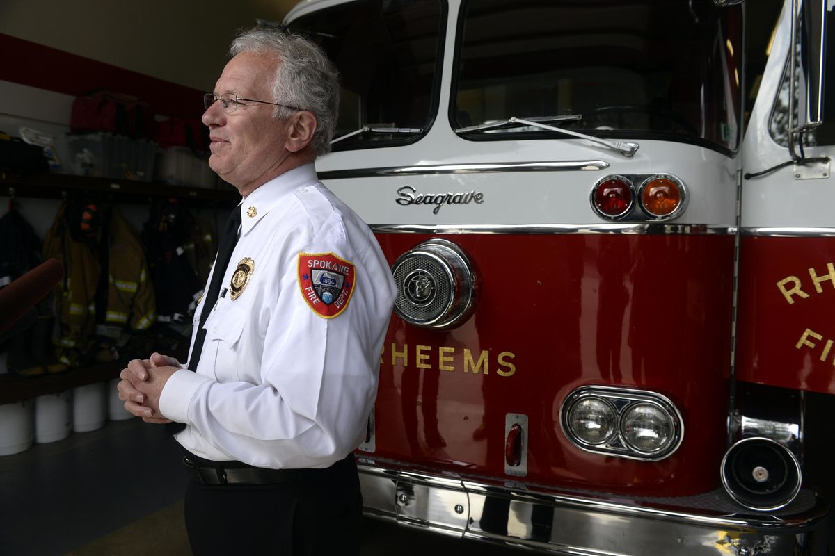 Spokane Fire Chief Bobby Williams talks to the media about the 1965 Seagrave firetruck he once used to help his Fire Explorers learn about the fire service Monday, April 28, 2014, at Spokane Fire Station 11. (Jesse Tinsley / The Spokesman-Review)