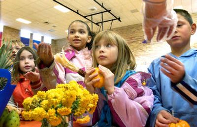 
Trent Elementary School second-graders Tabitha Armstrong, Naiviv Fisk, Wesley Cocke  and Andrew Ray wait to taste edible flowers at the school's Harvest Festival on Monday. Trent Elementary is one of two Spokane County schools  to receive a grant to provide fruits and vegetables to students. 
 (Joe Barrentine / The Spokesman-Review)
