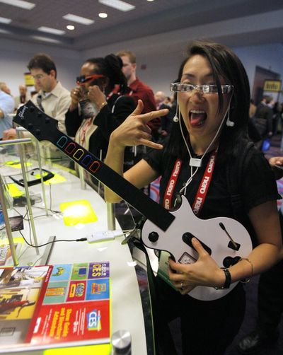 Judy Mellett, of Toronto, poses while playing a video game through Myvu’s personal media viewer at the Consumer Electronics Show in Las Vegas.   (File Associated Press / The Spokesman-Review)
